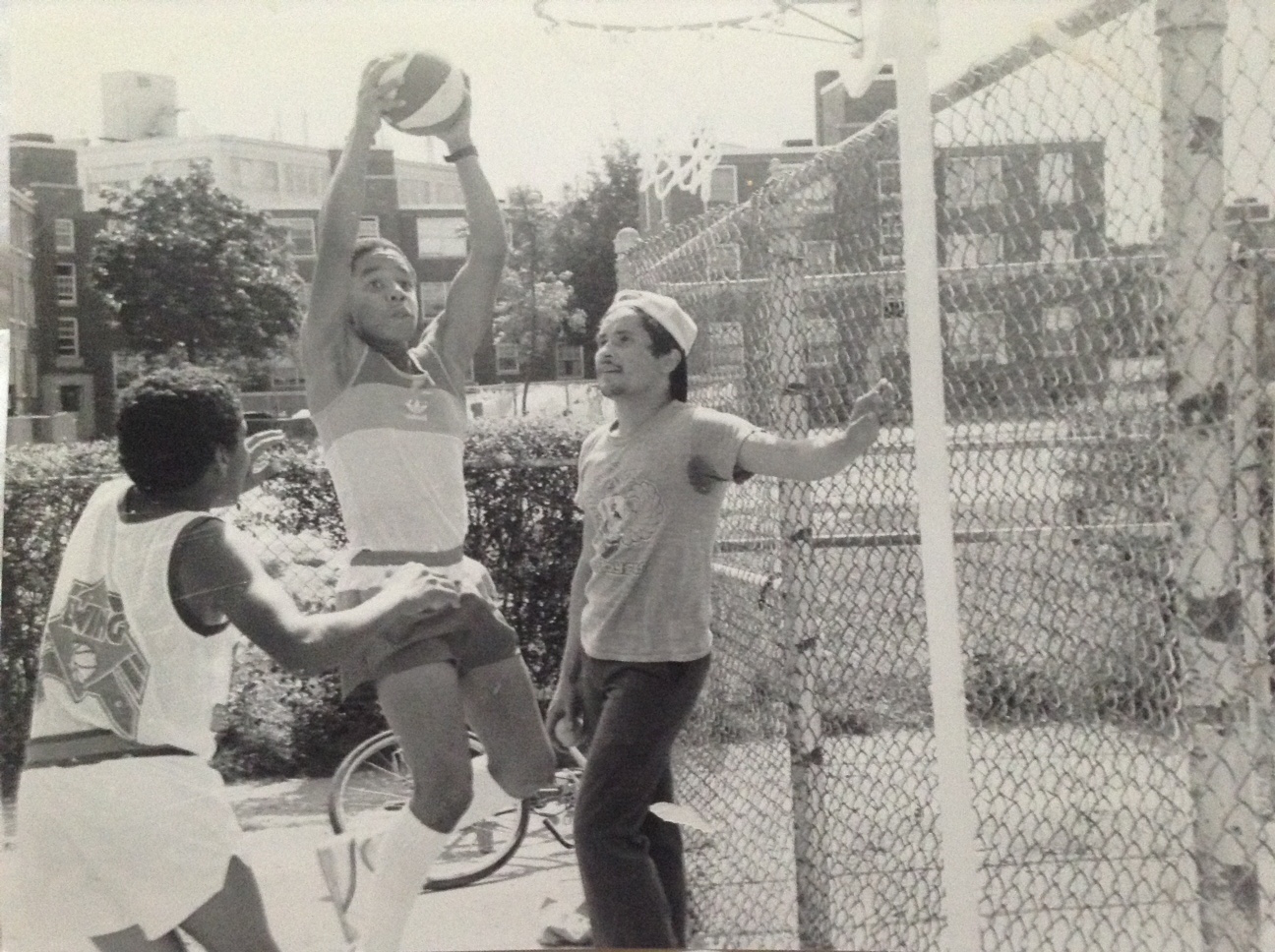Tico Garcia (left) plays basketball with his twin, Daco Garcia, as Rainier Rosado looks on.