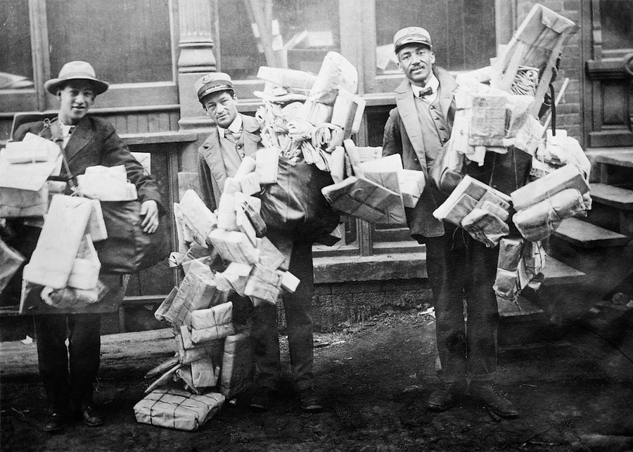 Mail carriers loaded with Christmas mail. Credit: Library of Congress.