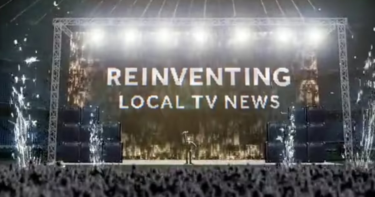 Image of a crowd in front of a stage. On stage, bright lights surround a screen that says "REINVENTING LOCAL TV NEWS" there is a person on the stage too.