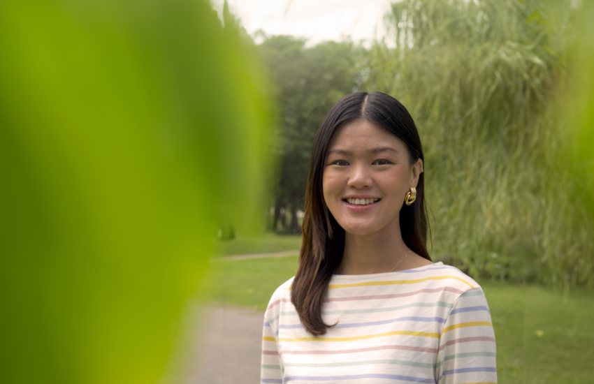 headshot of angela on green background
