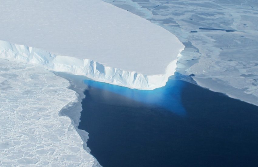 Aerial photo shows melting glacier with large crack in the middle.
